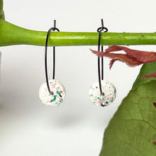 Load image into Gallery viewer, Black hoops with white polymer clay circles on a rose stem