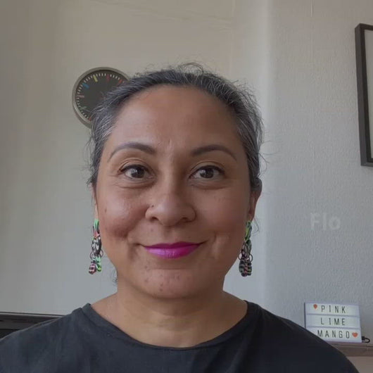 A video of Vicky from Pink Lime Mango modelling handcrafted Flo earrings for size reference. Bright, bold and colourful earrings made in Bristol UK
