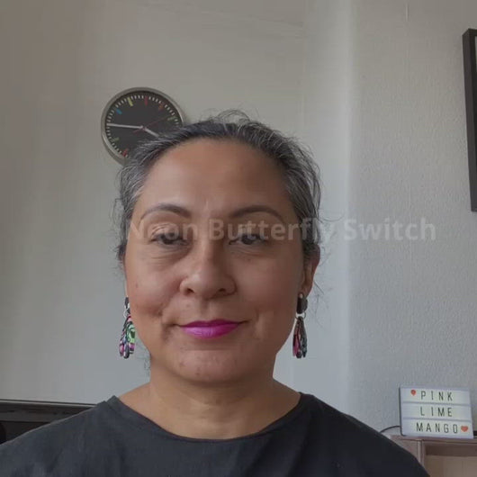 A video of Vicky from Pink Lime Mango modelling handcrafted Neon Butterfly Switch earrings for size reference. Bright, bold and colourful earrings made in Bristol UK