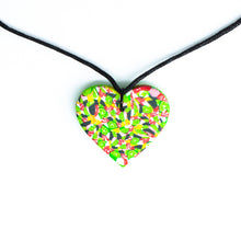 Load image into Gallery viewer, A unique heart necklace handcrafted in the UK by Bristol based Artist and Jeweller, Vicky Takooree. The distinctive multi-coloured pattern from Pink Lime Mango includes zesty green lime shapes, dark green, marbled red and white, yellow and pink elements! With an adjustable black waxed cotton cord.