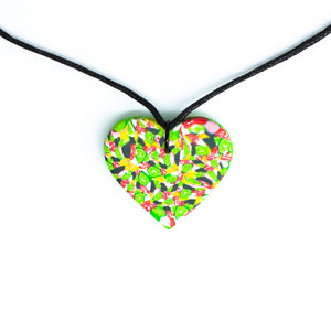 A unique heart necklace handcrafted in the UK by Bristol based Artist and Jeweller, Vicky Takooree. The distinctive multi-coloured pattern from Pink Lime Mango includes zesty green lime shapes, dark green, marbled red and white, yellow and pink elements! With an adjustable black waxed cotton cord.