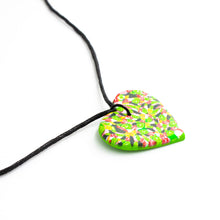 Load image into Gallery viewer, A unique heart necklace handcrafted in the UK by Bristol based Artist and Jeweller, Vicky Takooree. The distinctive multi-coloured pattern from Pink Lime Mango includes zesty green lime shapes, dark green, marbled red and white, yellow and pink elements! With an adjustable black waxed cotton cord.
