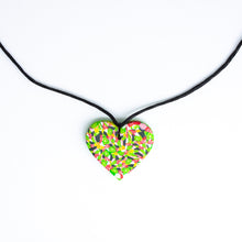 Load image into Gallery viewer, A unique heart necklace handcrafted in the UK by Bristol based Artist and Jeweller, Vicky Takooree. The distinctive multi-coloured pattern from Pink Lime Mango includes zesty green lime shapes, dark green, marbled red and white, yellow and pink elements! With an adjustable black waxed cotton cord.