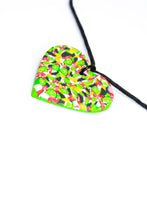 Load image into Gallery viewer, A unique heart necklace handcrafted in the UK by Bristol based Artist and Jeweller, Vicky Takooree. The distinctive multi-coloured pattern from Pink Lime Mango includes zesty green lime shapes, dark green, marbled red and white, yellow and pink elements! With an adjustable black waxed cotton cord.