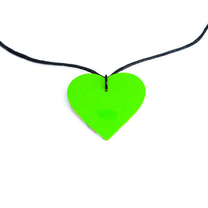 The green base which is on the back of the heart pendant. With an adjustable black waxed cotton cord.
