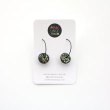 Load image into Gallery viewer, Black glitter sparkly discs on stainless steel black hoops! These feature iridescent glitter which changes between blue, gold and green. Unique and one of a kind!