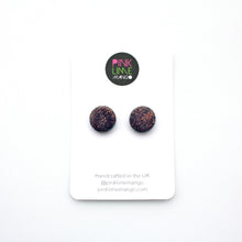 Load image into Gallery viewer, Handcrafted studs in a dark purple colour overlaid with iridescent glitter which shimmers between gold, green and blue. Unique and one of a kind! Featuring silver plated stud posts and earring backs.