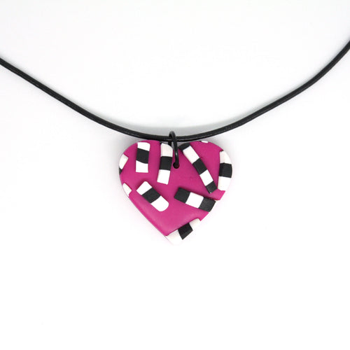 A beautiful one of a kind necklace - bold textured stripy pieces with a pink heart background.