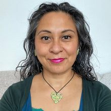 Load image into Gallery viewer, A unique heart necklace handcrafted in the UK by Bristol based Artist and Jeweller, Vicky Takooree. The distinctive multi-coloured pattern from Pink Lime Mango includes zesty green lime shapes, dark green, marbled red and white, yellow and pink elements! Modelled by Vicky in this photo.