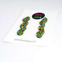 Load image into Gallery viewer, Side view - Statement squiggle earrings with a beautiful mosaic pattern of marbled brown, green, cream, bright red, electric blue, mango orange with a chocolate coloured brown base. Placed on a white backing card with the Pink Lime Mango logo.