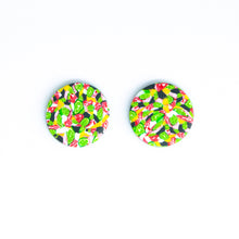 Load image into Gallery viewer, Bright bold and colourful statement studs! They are handcrafted in the UK by Bristol based Artist and Jeweller, Vicky Takooree. The distinctive multi-coloured pattern from Pink Lime Mango includes zesty green lime shapes, dark green, marbled red and white, yellow and pink elements! They are made of very lightweight polymer clay.
