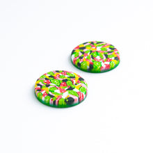Load image into Gallery viewer, Bright bold and colourful statement studs! They are handcrafted in the UK by Bristol based Artist and Jeweller, Vicky Takooree. The distinctive multi-coloured pattern from Pink Lime Mango includes zesty green lime shapes, dark green, marbled red and white, yellow and pink elements! They are made of very lightweight polymer clay. Side view.