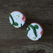 Load image into Gallery viewer, Our beautiful apple stud earrings. Inspired by a sunny walk in June through the crab apple trees. Lightweight earrings with raised and textured detailing in light blue, mint green, dark green and pink with a light brown base.