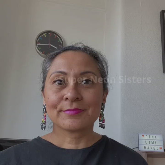 A video of Vicky from Pink Lime Mango modelling handcrafted Super Neon Sisters earrings for size reference. Bright, bold and colourful earrings made in Bristol UK