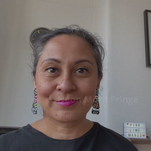 A video of Vicky from Pink Lime Mango modelling handcrafted Neon Moth Fringe earrings for size reference. Bright, bold and colourful earrings made in Bristol UK