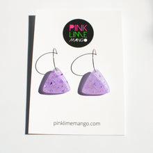 Load image into Gallery viewer, Sparkly lilac triangular earrings from the Under the Sea resin collection. Beautiful layers of fine iridescent glitter, colour shifting aurora flakes and tiny pieces of metallic purple foil. A unique design that has been complimented with multicoloured rainbow hoops! With a Pink Lime Mango backing card.