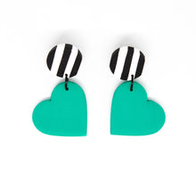 Load image into Gallery viewer, Bright, bold and colouful earrings with black and white striped stud top and a vibrant bright green heart. The earrings are handcrafted from lightweight polymer clay. Handmade by British artist, Vicky, in her home studio in Bristol, UK.