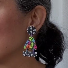 Load image into Gallery viewer, A video still of Vicky from Pink Lime Mango modelling handcrafted Neon Moth Fringe earrings for size reference. Bright, bold and colourful earrings made in Bristol UK