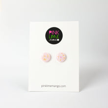 Load image into Gallery viewer, handcrafted bubble-gum pink resin statement studs. They contain the most amazing aurora glitter flakes. Colour changing iridescent pieces which shine when they catch the light. The earrings posts are made of sterling silver. Earrings shown on a Pink Lime Mango backing card