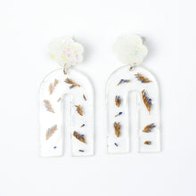Load image into Gallery viewer, Handcrafted earrings with arches of clear resin containing sea lavender flowers. The stud top is a white flower containing the most wonderful colourful changing aurora flakes of glitter.
