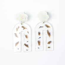 Load image into Gallery viewer, Handcrafted earrings with arches of clear resin containing sea lavender flowers. The stud top is a white flower containing the most wonderful colourful changing aurora flakes of glitter.