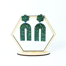 Load image into Gallery viewer, Hexagonal earring display stand. Handcrafted resin arch earrings that are jam packed with sparkly teal blue, green and gold glitter! These beauties have flower stud tops and look fabulous on!