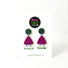 Load image into Gallery viewer, Earrings displayed on a Pink Lime Mango backing card. Handcrafted resin earrings decorated with teal blue and purple glitter. The round stud top has a been jam packed with gorgeous sparkly blue and green glitter. The middle triangle piece is fabulously purple and glittery! The three bumps piece at the bottom has clear resin with teal glitter edging.
