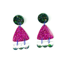 Load image into Gallery viewer, Side angle view. Handcrafted resin earrings decorated with teal blue and purple glitter. The round stud top has a been jam packed with gorgeous sparkly blue and green glitter. The middle triangle piece is fabulously purple and glittery! The three bumps piece at the bottom has clear resin with teal glitter edging.