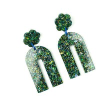 Load image into Gallery viewer, Side View. Handcrafted resin arch earrings that are jam packed with sparkly teal blue, green and gold glitter! These beauties have flower stud tops and look fabulous on!
