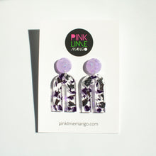Load image into Gallery viewer, Gorgeous handcrafted resin earrings with round glittery lilac stud tops! These beautiful arch dangle earrings are decorated with delicate pieces of silver and purple foils. Pictured with a Pink Lime Mango earring backing card.
