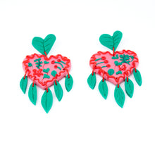 Load image into Gallery viewer, The Green Planet earrings. The stud tops are green leaves that are also abstract heart shapes. The pink heart in the middle is decorated with red and green swirls, minitaure leaves and flowers. The earrings have a delicate fringe of hand cut leaves and they hang beautifully!
