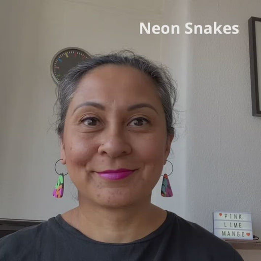 A video of Vicky from Pink Lime Mango modelling handcrafted Neon Snakes earrings for size reference. Bright, bold and colourful earrings made in Bristol UK