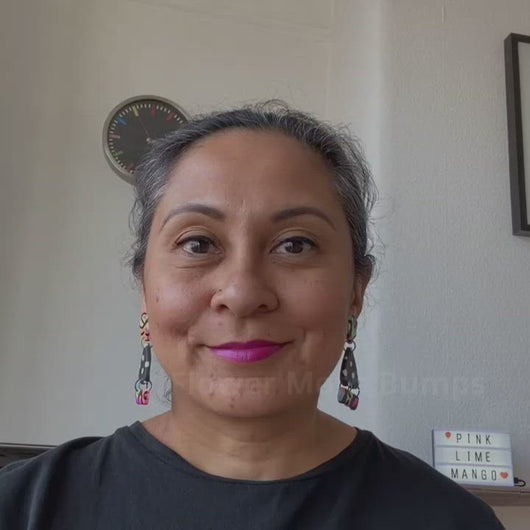 A video of Vicky from Pink Lime Mango modelling handcrafted Flower Moth Bumps earrings for size reference. Bright, bold and colourful earrings made in Bristol UK