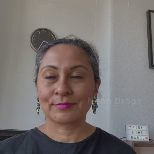 A video of Vicky from Pink Lime Mango modelling handcrafted Neon Drops earrings for size reference. Bright, bold and colourful earrings made in Bristol UK