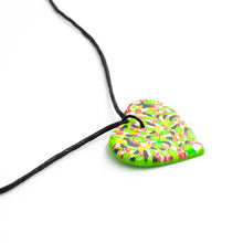Load image into Gallery viewer, A unique heart necklace handcrafted in the UK by Bristol based Artist and Jeweller, Vicky Takooree. The distinctive multi-coloured pattern from Pink Lime Mango includes zesty green lime shapes, dark green, marbled red and white, yellow and pink elements! With an adjustable black waxed cotton cord.

