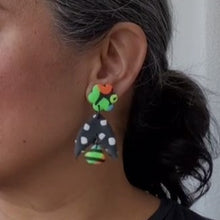 Load image into Gallery viewer, A video still of Vicky from Pink Lime Mango modelling handcrafted Neon Flower Batwing earrings for size reference. Bright, bold and colourful earrings made in Bristol UK
