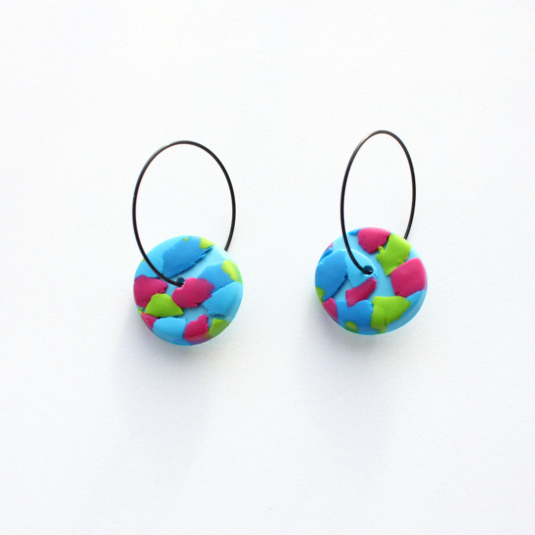 A unique, joyful and vibrant earring design! Named after Eric Carle, author and illustrator of the beautiful children's book The Very Hungry Caterpillar! My favourite book to read both as a child and as a mum!  Abstract blue, green and pink detailing on a light blue small circular base. Styled with contemporary stainless steel black hoops. Lightweight, handcrafted and one of a kind!