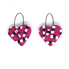Load image into Gallery viewer, Vibrant pink hearts with 3D black and white striped detailing. Styled with stainless steel black hoops. Lightweight, handcrafted and one of a kind!
