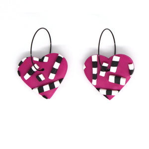 Vibrant pink hearts with 3D black and white striped detailing. Styled with stainless steel black hoops. Lightweight, handcrafted and one of a kind!