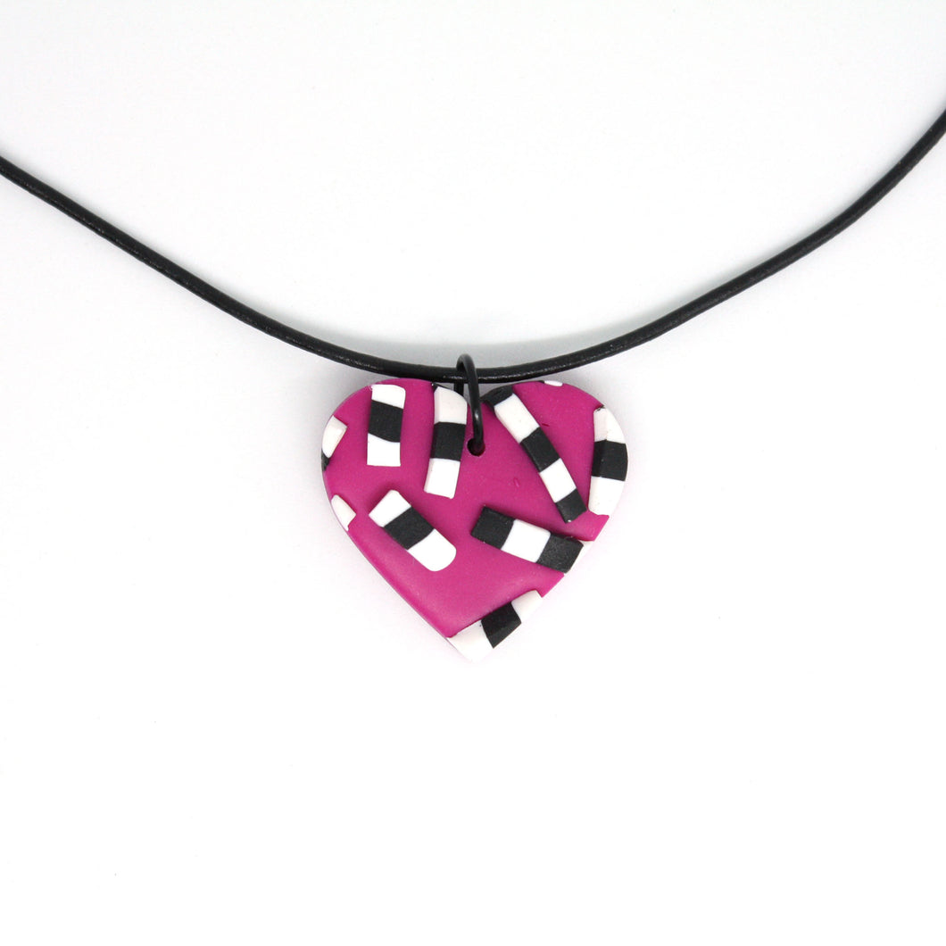 A beautiful one of a kind necklace - bold textured stripy pieces with a pink heart background.