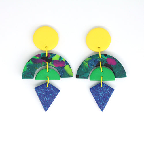 Beacon, a stunning pair of statement earrings, in the following layers, a vibrant yellow circle stud top, marbled glitter arch in deep green with multicoloured swirls encasing a bright green semi circle and a diamond shaped blue glitter piece at the bottom. Finished with a lovely detail - gorgeous yellow jump rings!