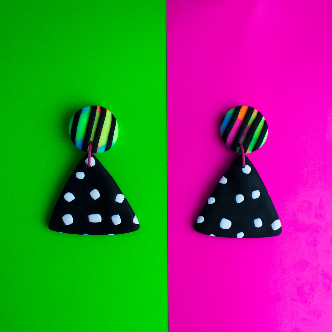 Dial Up! Check out the unique Status Earrings Collection! Stunning bold statement dangles which have black and white triangle shapes topped with neon and raised black stripe textured studs! 