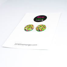 Load image into Gallery viewer, Bright bold and colourful statement studs! They are handcrafted in the UK by Bristol based Artist and Jeweller, Vicky Takooree. The distinctive multi-coloured pattern from Pink Lime Mango includes zesty green lime shapes, dark green, marbled red and white, yellow and pink elements! They are made of very lightweight polymer clay. Attached to a white backing card with the Pink Lime Mango logo at the top.
