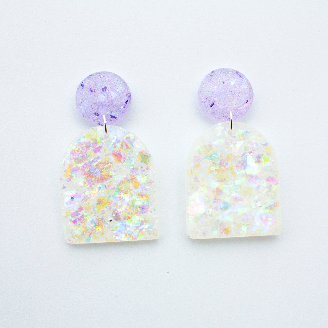 Arch shaped colour shift dangle earrings with lilac glitter stud tops.