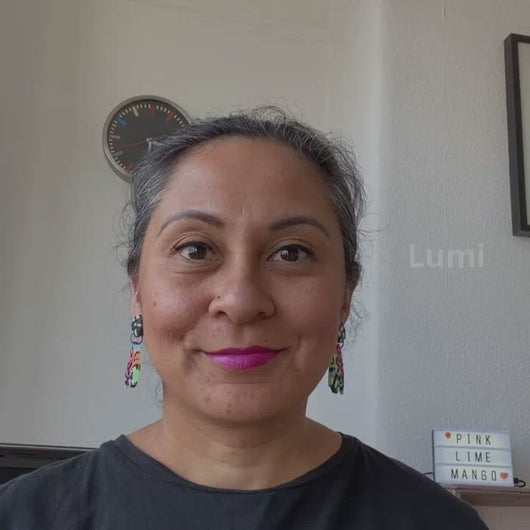A video of Vicky from Pink Lime Mango modelling handcrafted Lumi earrings for size reference. Bright, bold and colourful earrings made in Bristol UK