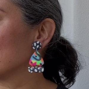 A video still of Vicky from Pink Lime Mango modelling handcrafted earrings for size reference. Bright, bold and colourful Dexy earrings made in Bristol UK