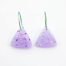 Load image into Gallery viewer, Sparkly lilac triangular earrings from the Under the Sea resin collection. Beautiful layers of fine iridescent glitter, colour shifting aurora flakes and tiny pieces of metallic purple foil. A unique design that has been complimented with multicoloured rainbow hoops!
