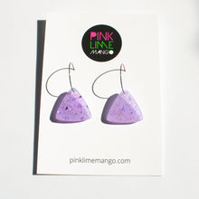 Load image into Gallery viewer, Sparkly lilac triangular earrings from the Under the Sea resin collection. Beautiful layers of fine iridescent glitter, colour shifting aurora flakes and tiny pieces of metallic purple foil. A unique design that has been complimented with multicoloured rainbow hoops! With a Pink Lime Mango backing card.
