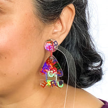 Load image into Gallery viewer, Handcrafted clear resin earrings decorated with multi-coloured foil letters! Model shots
