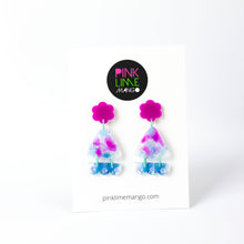 Load image into Gallery viewer, Vibrant handcrafted resin earrings with a pink flower top, the middle parts are frosted white triangles with pink cloud patterns and a sprinkling of electric blue glitter. The base element has sparkly lilac flowers perfectly placed above a layer of electric blue glitter. Complimented with mint green jump rings. Earrings on a Pink Lime Mango backing card.
